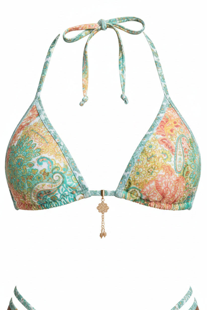 Close-up detail of mint green paisley print bikini top showing fabric texture and gold charm